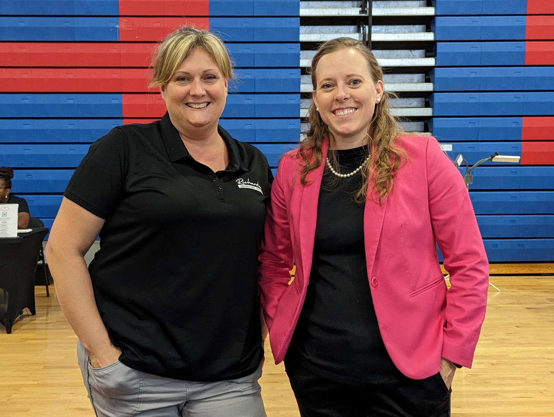 Amy and Danelle standing side by side at a speaking event