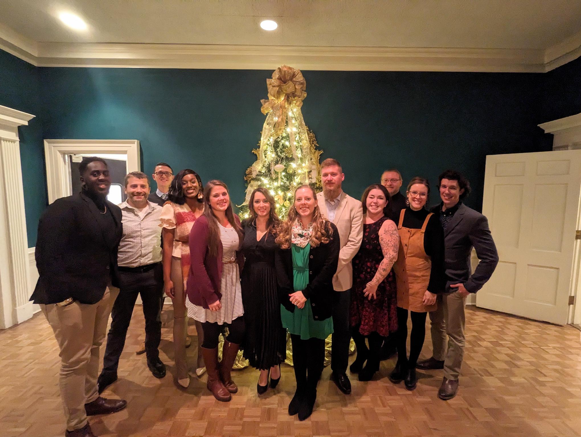 RPS team and their spouses at a christmas party, gathered in front of a tree, december 2022